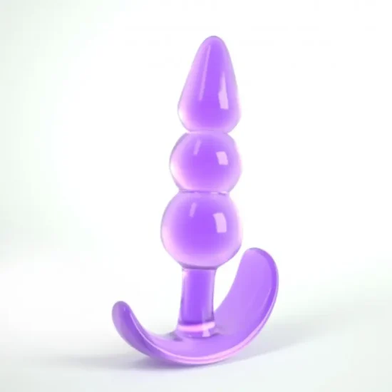 Plug anal The Plunger Crushious em silicone preto visto de frente numa superfície neutra.